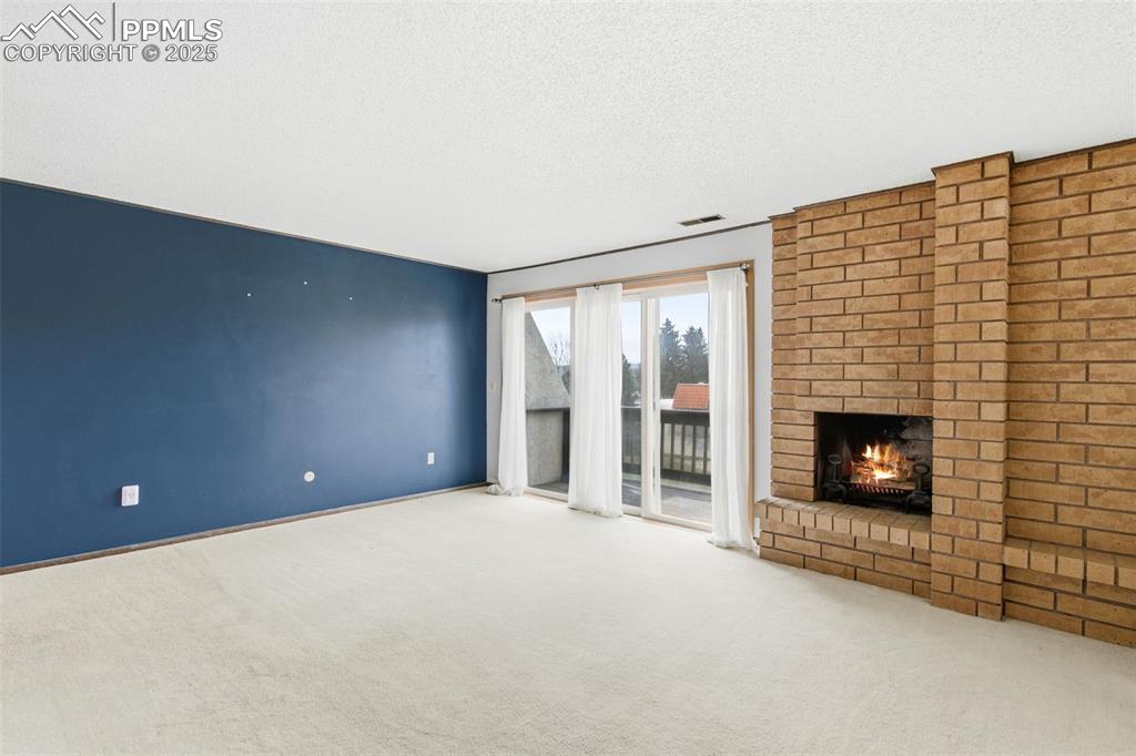 Image 24 of 45: Primary Bedroom  featuring a brick fireplace