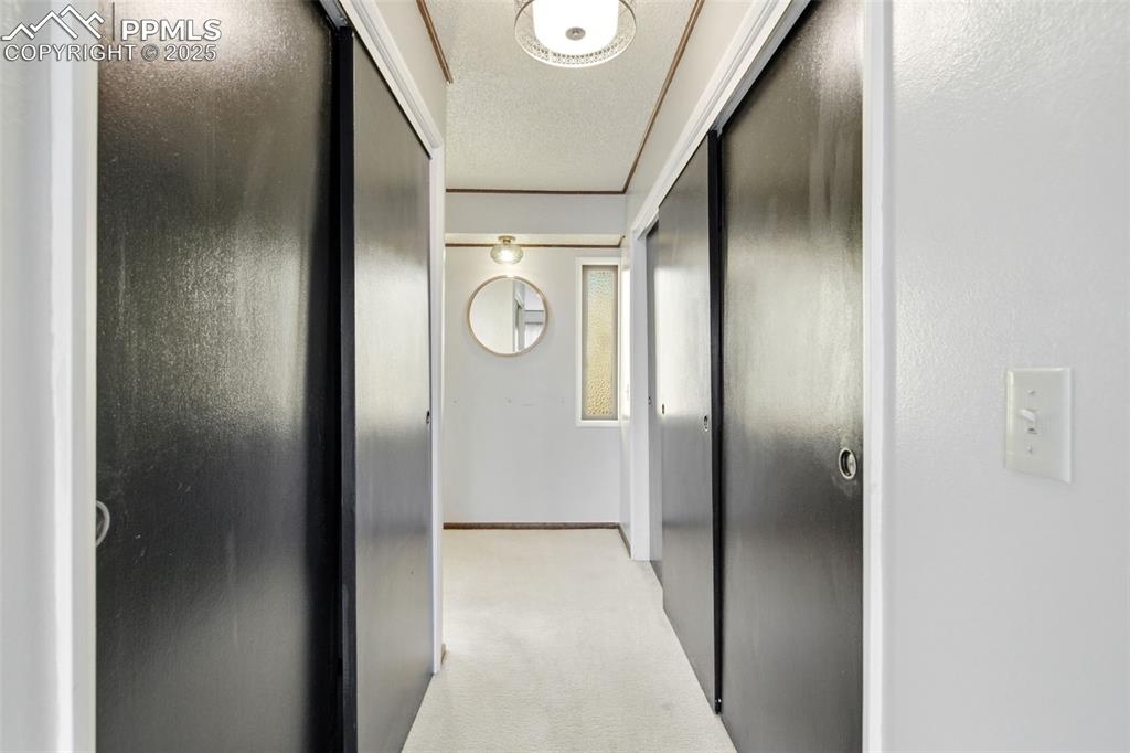 Image 26 of 45: Corridor featuring light colored carpet 