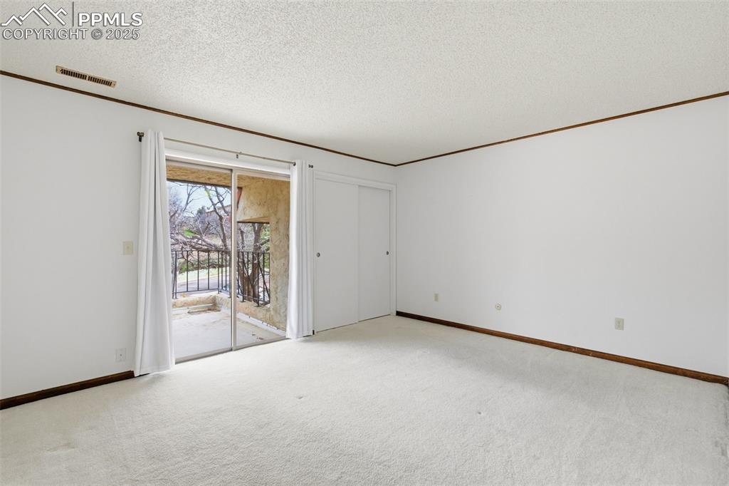 Image 29 of 45: Spare room with door to deck