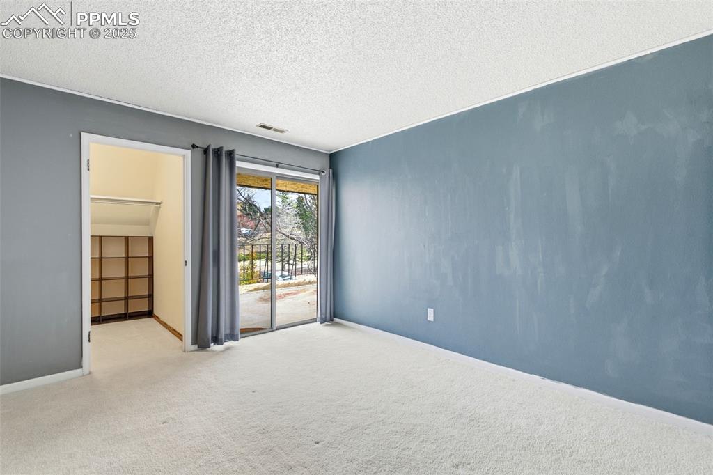 Image 30 of 45: Carpeted spare room with door to deck