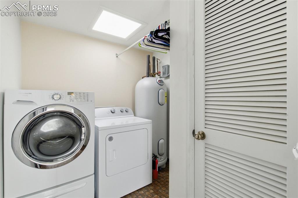 Image 32 of 45: Laundry room with washer and clothes dryer and water heater