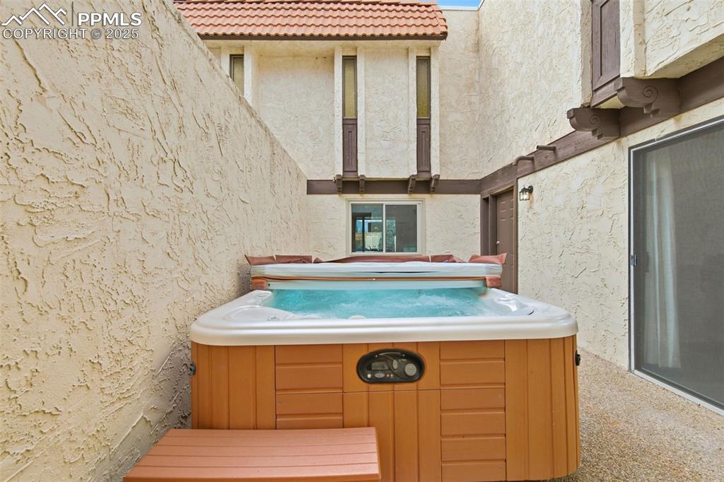 Image 36 of 45: View of patio / terrace with a hot tub