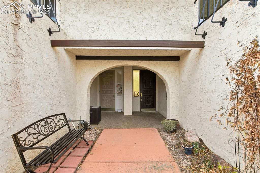 Image 7 of 45: Doorway to property featuring stucco siding
