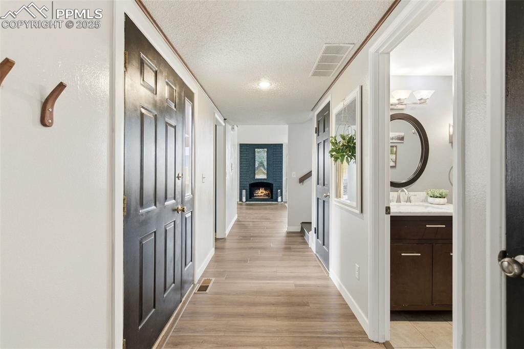 Image 8 of 45: Hall featuring light wood finished floors