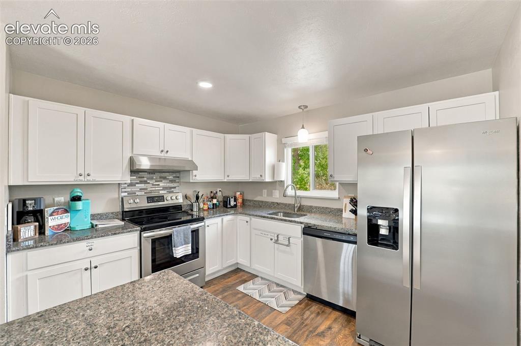 Image 12 of 50: Enjoy the updated kitchen with stainless steel appliances and granite count