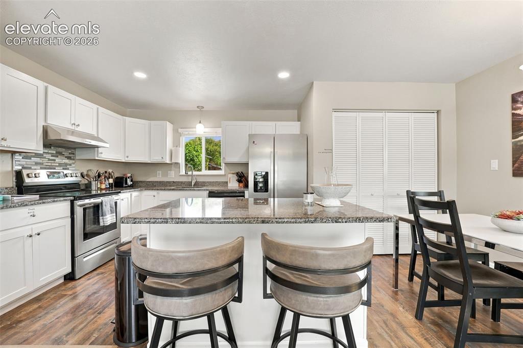 Image 15 of 50: Counter top eating in updated kitchen!