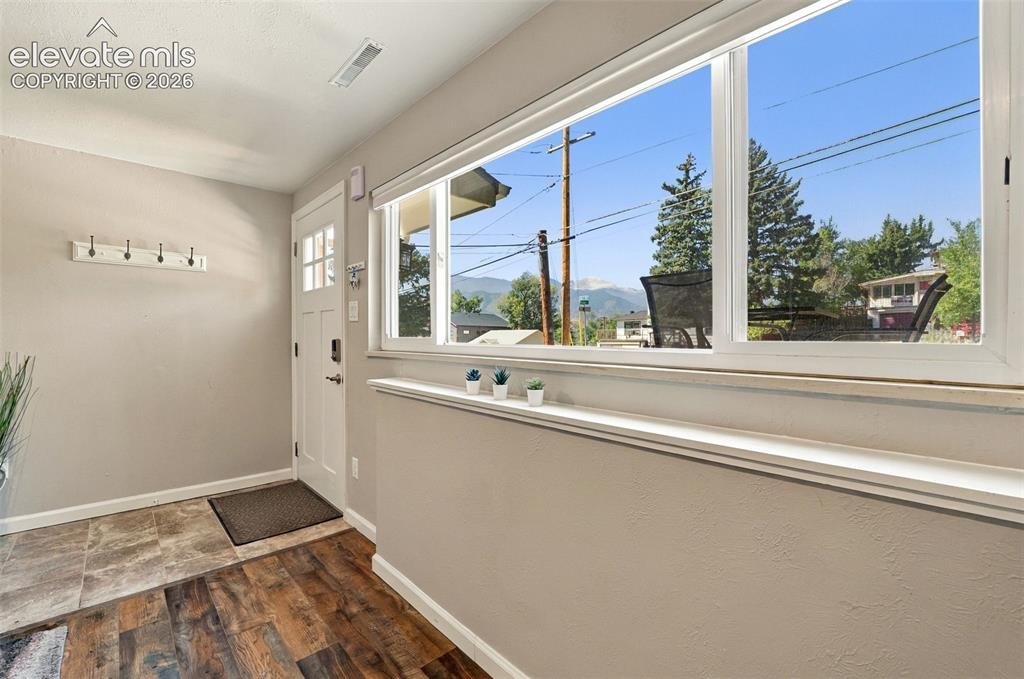 Image 29 of 50: Entryway to lower level unit and window out the front