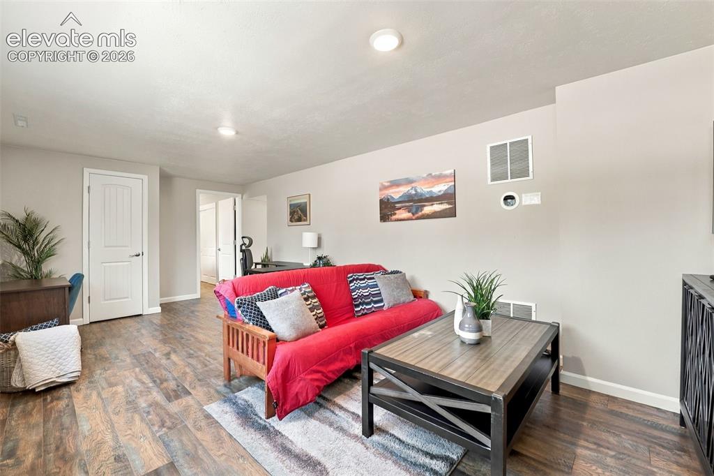 Image 31 of 50: Living room in lower level with updated luxury vinyl flooring!