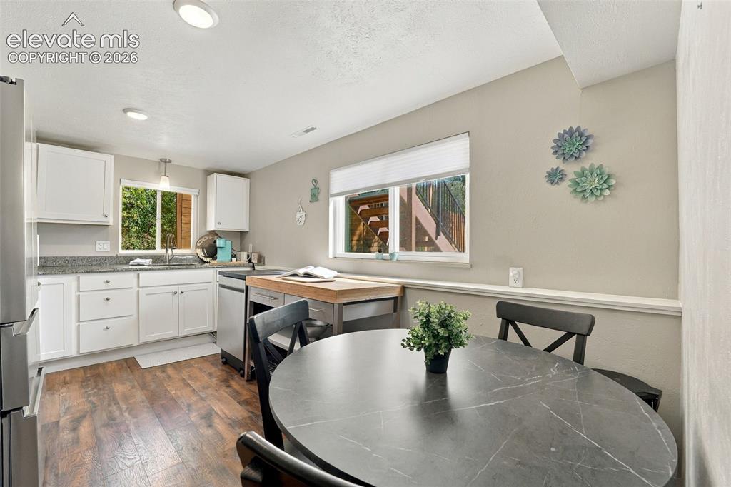 Image 36 of 50: Lower level kitchen and dining area.