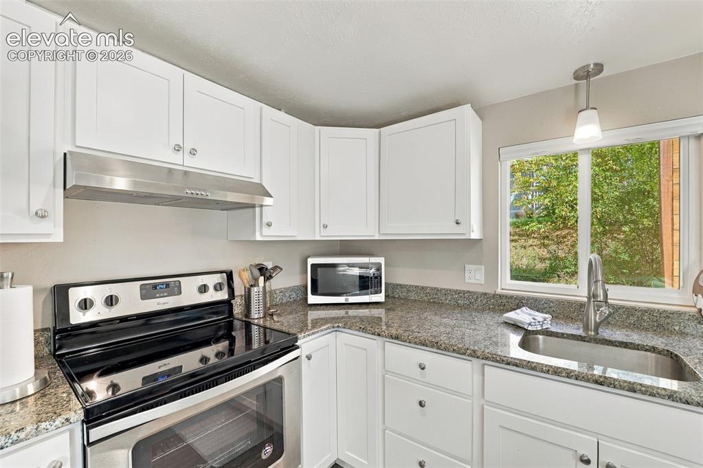 Image 38 of 50: Updated counters and cabinets in the lower level kitchen!