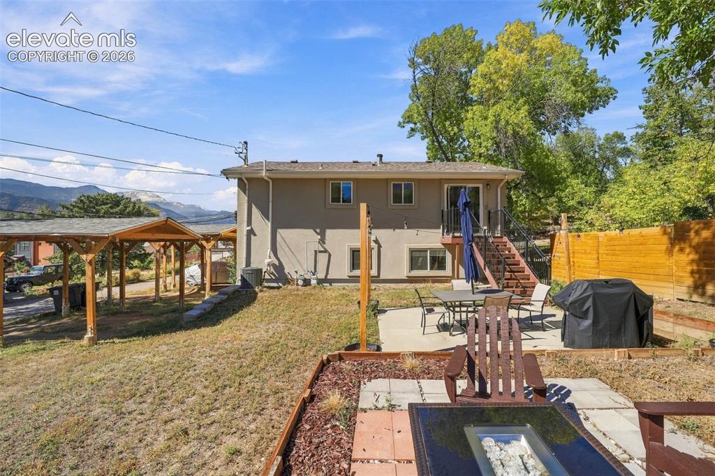 Image 42 of 50: Enjoy the gas fire pit and views of Pikes Peak from the large back yard!