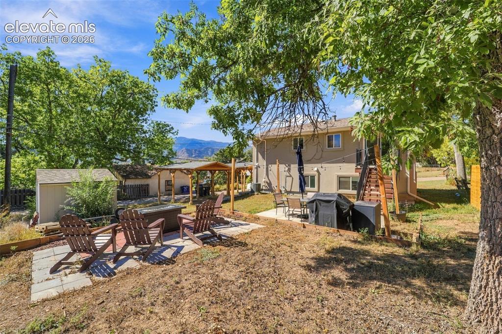 Image 45 of 50: Back yard with multiple spaces for use!