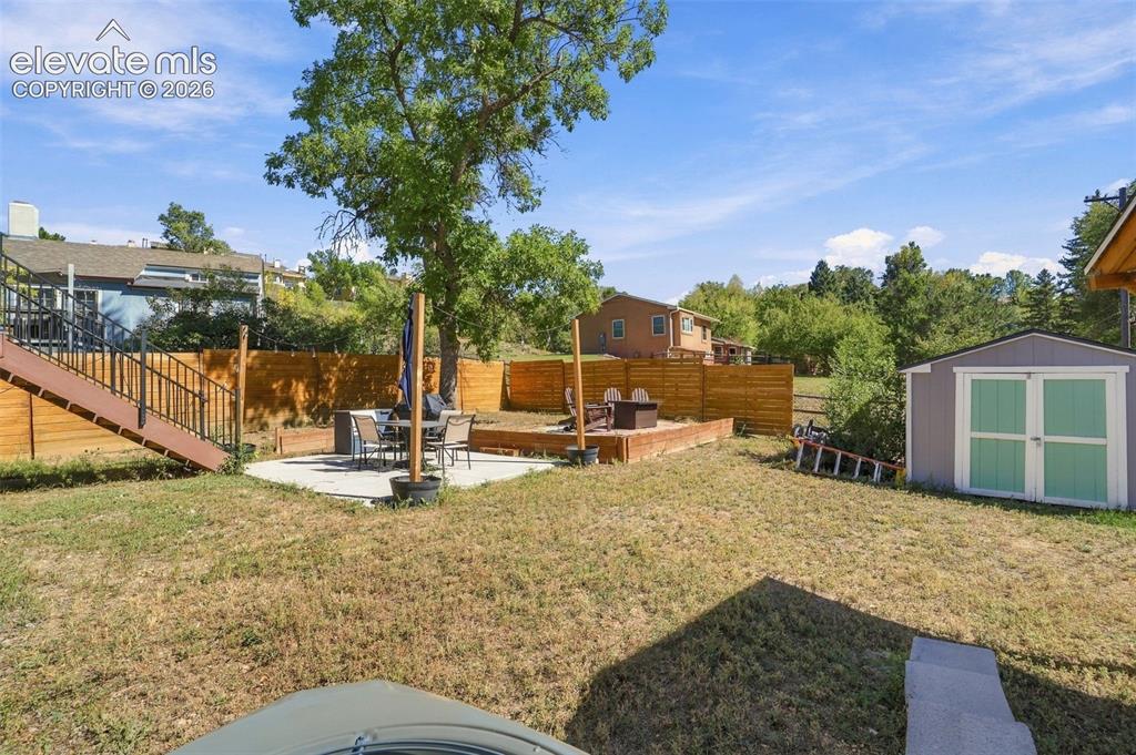 Image 46 of 50: Back yard with storage shed too!