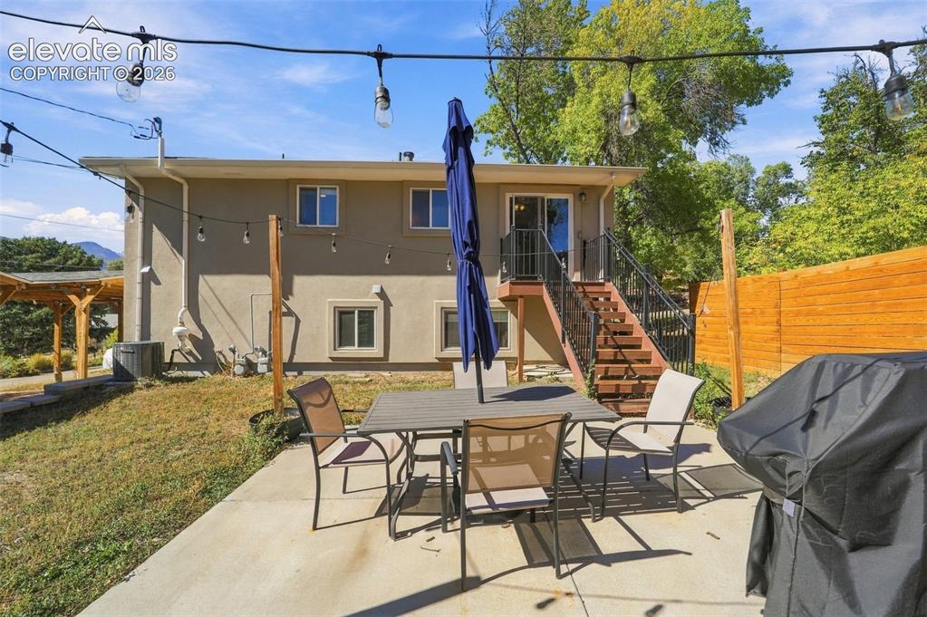 Image 47 of 50: Back yard patio and privacy fence