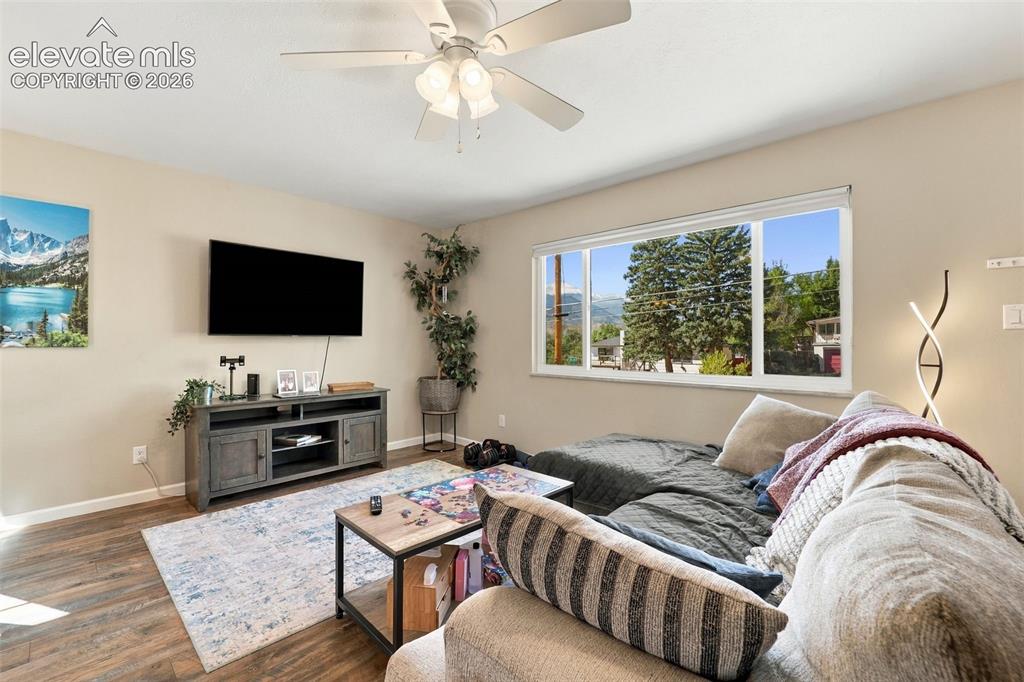 Image 9 of 50: Large picture window in upper level with views of Pikes Peak! 