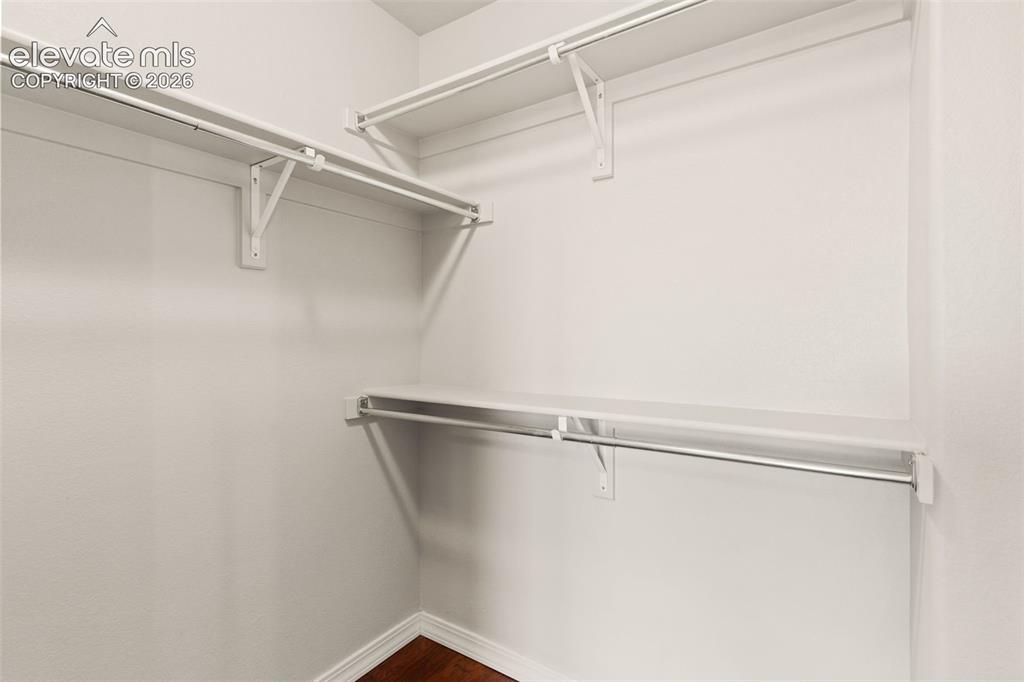 Image 18 of 29: Walk in closet in primary bedroom