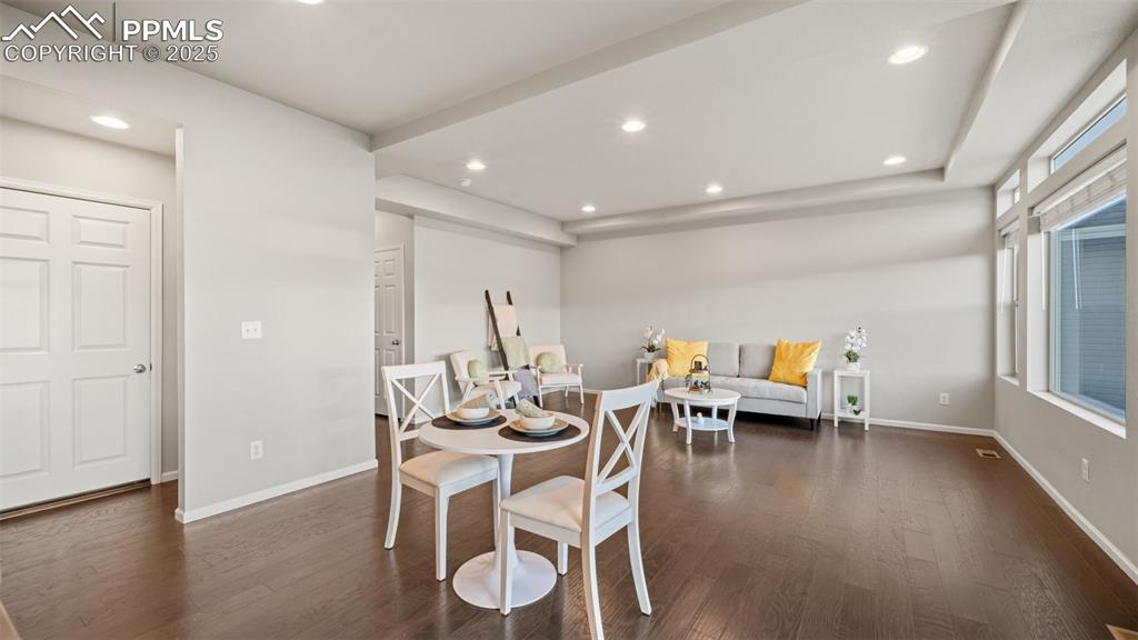 Image 14 of 48: Dining area with dark wood-type flooring and recessed lighting