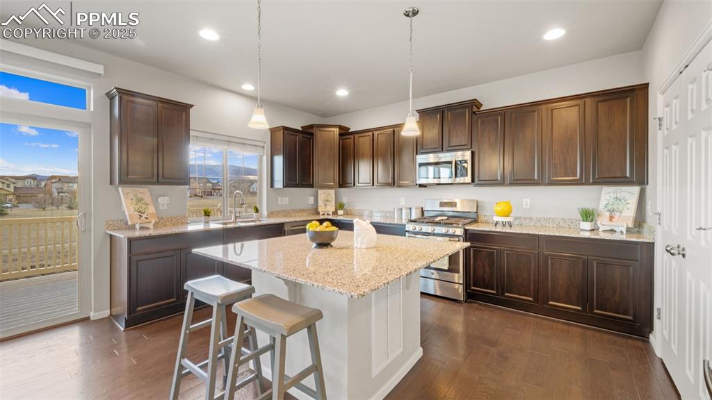 Image 19 of 48: Kitchen featuring appliances with stainless steel finishes, pendant lightin