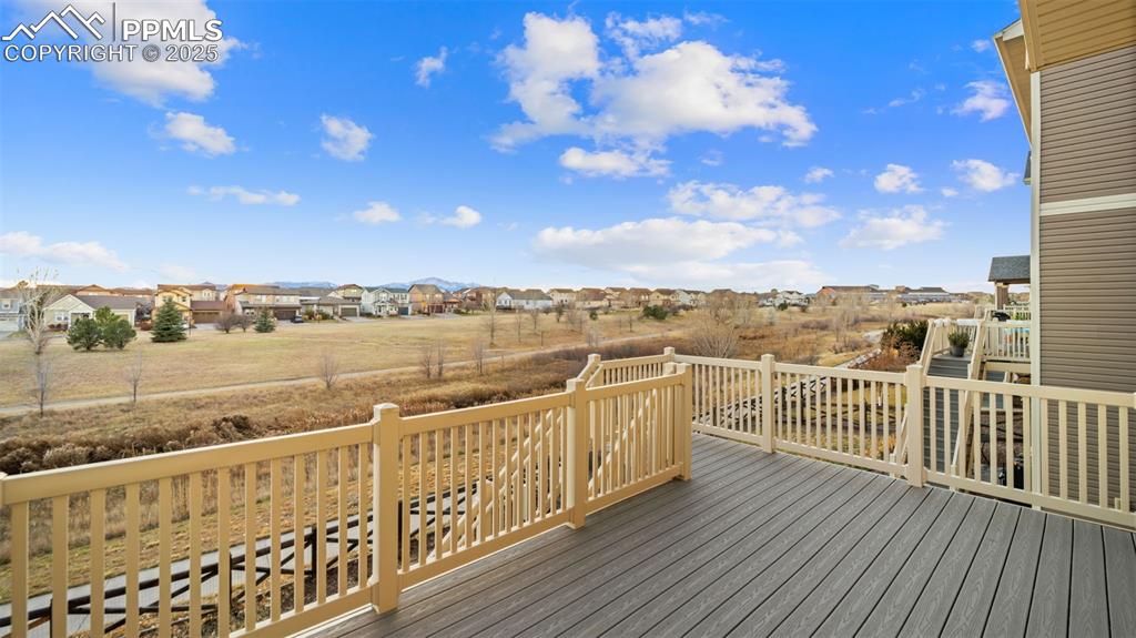 Image 20 of 48: Wooden terrace with a view of the yard and walking trail