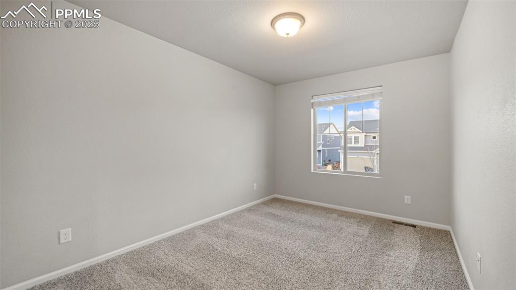 Image 32 of 48: secondary bedroom featuring carpet and baseboards