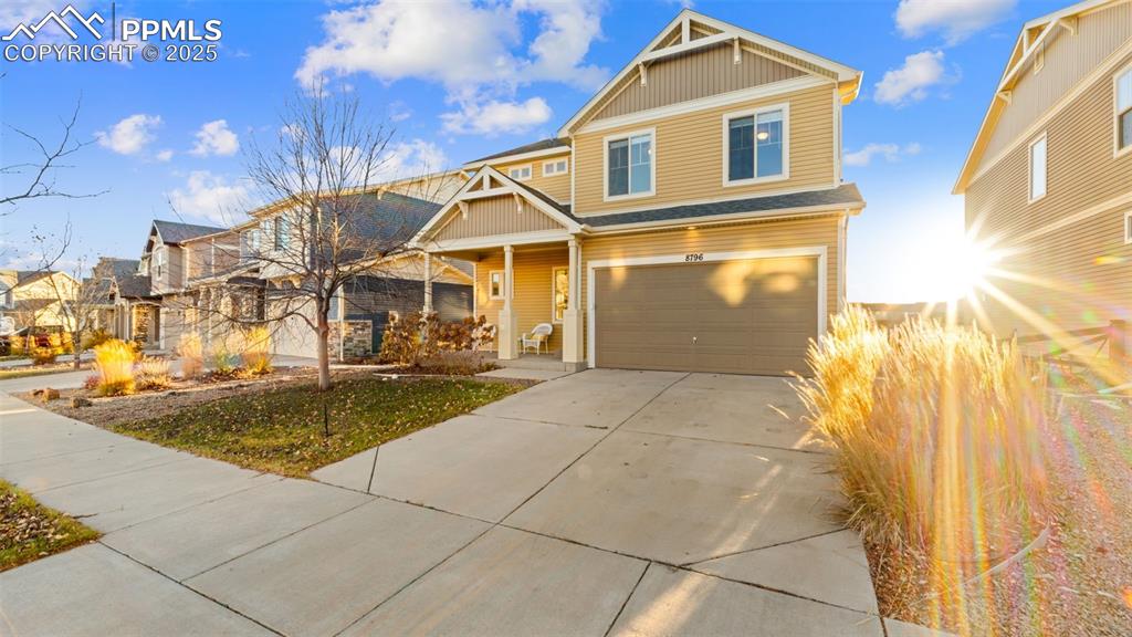 Image 5 of 48: Craftsman house featuring driveway, an attached garage, and a residential v