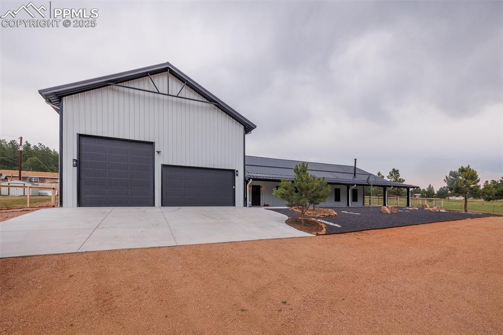 Image 3 of 38: View of front of home with driveway