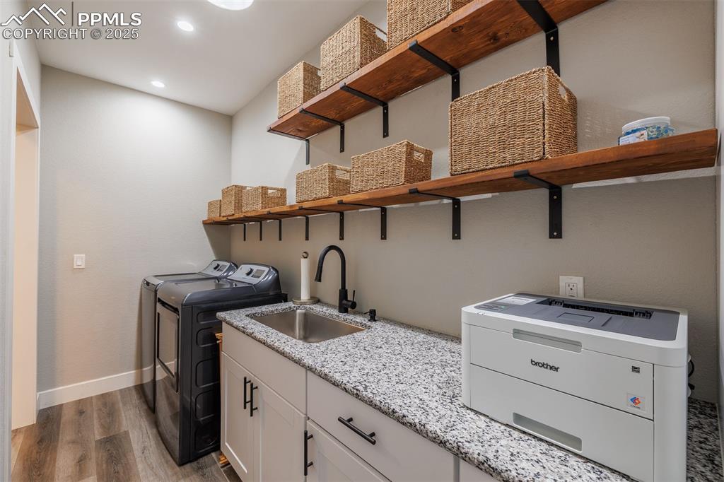 Image 33 of 38: Laundry room with washer and dryer, shelves and deep sink