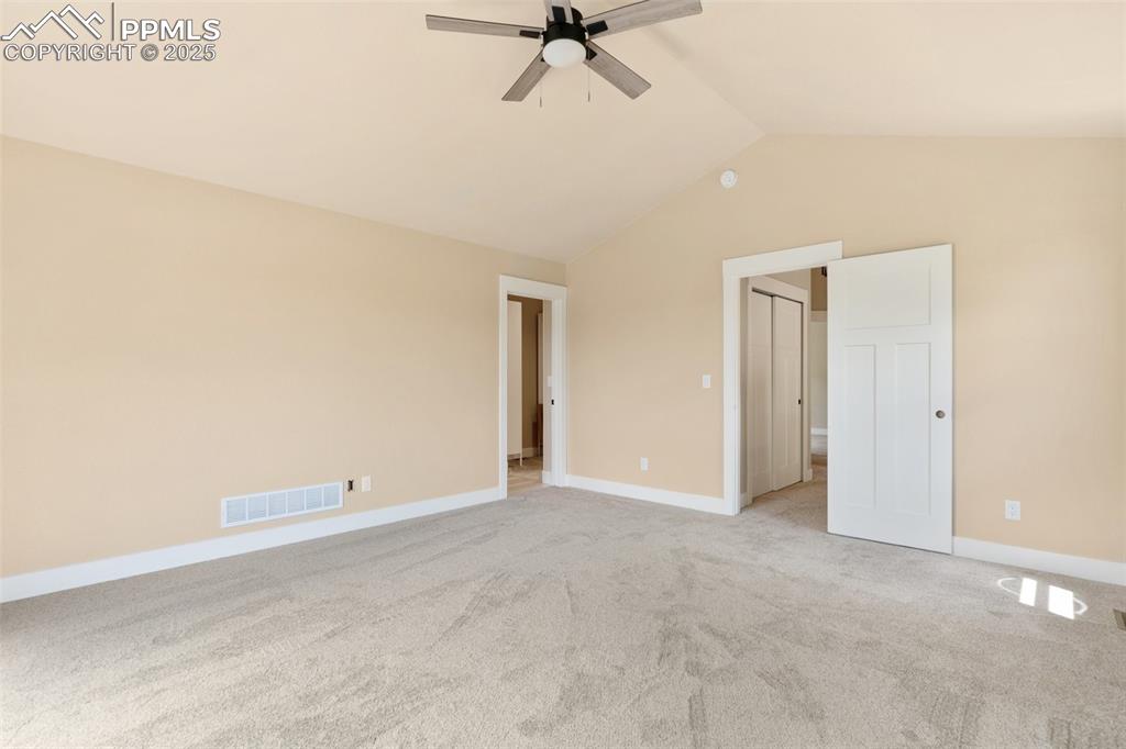 Image 17 of 33: Primary bedroom suite with private balcony with stunning Front Range views