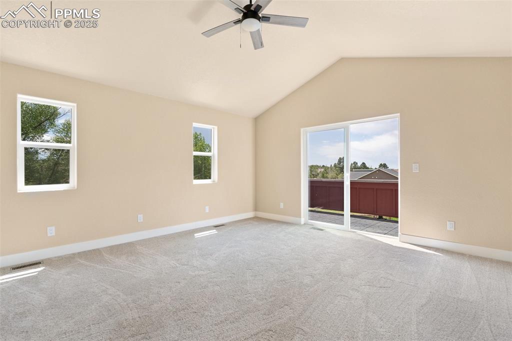 Image 18 of 33: Primary bedroom suite with private balcony with stunning Front Range views