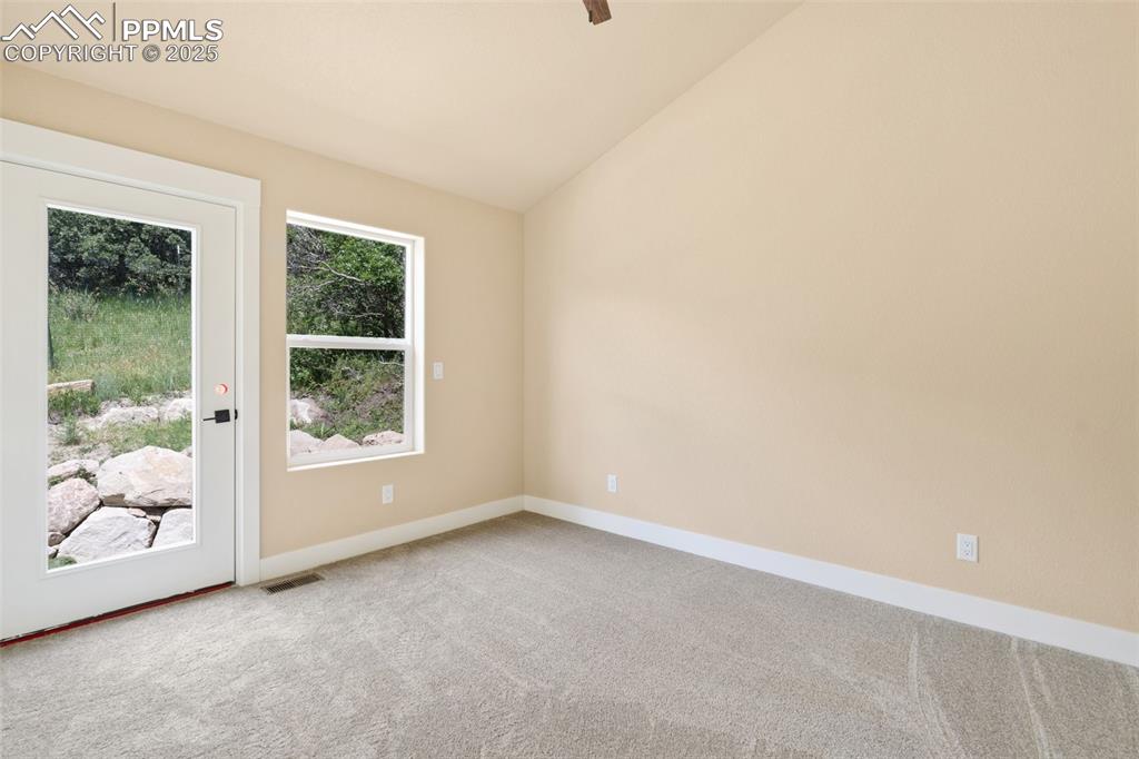 Image 23 of 33: 2nd bedroom on upper level, with private walk-out to the backyard