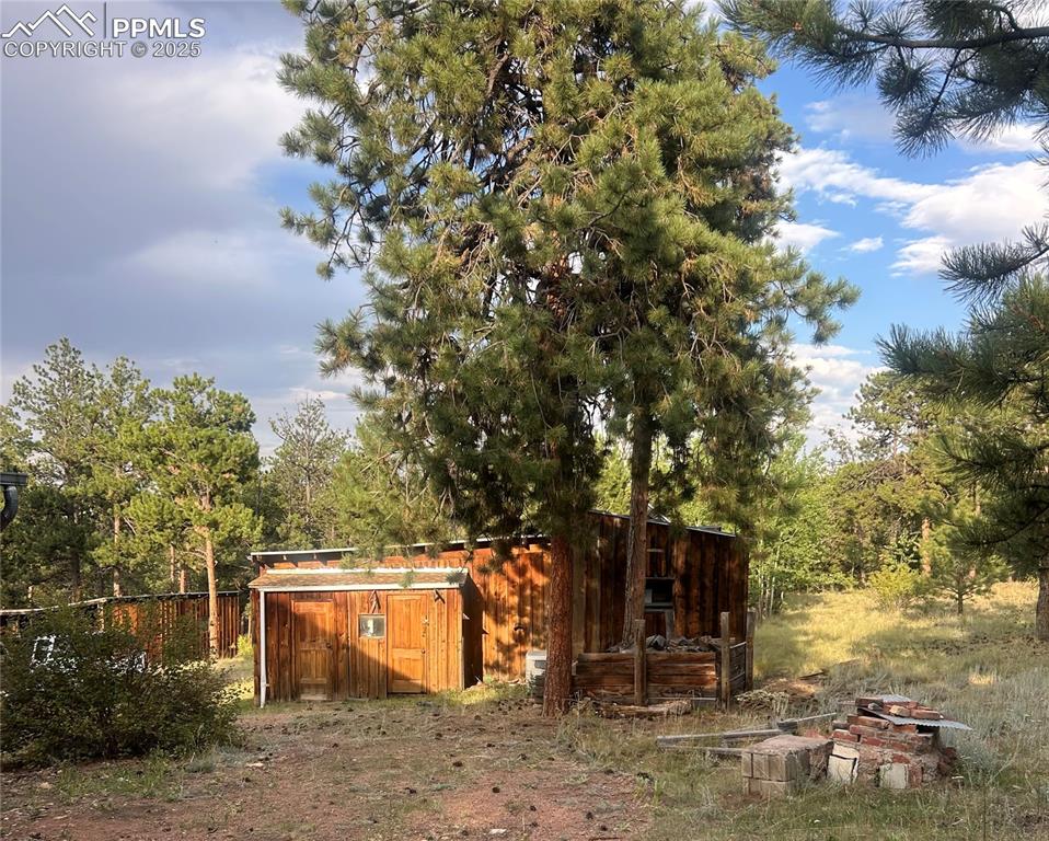 Image 16 of 40: View of yard featuring an outdoor structure