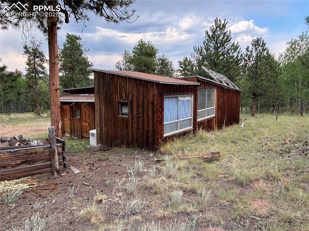 Image 17 of 40: View of property exterior featuring a wooded view
