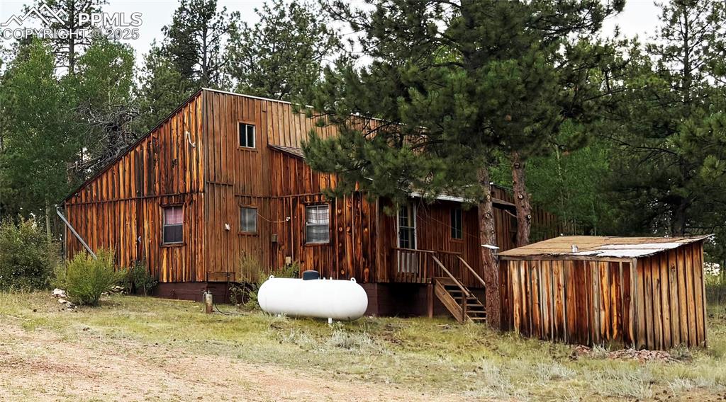 Image 2 of 40: View of outdoor structure featuring view of wooded area