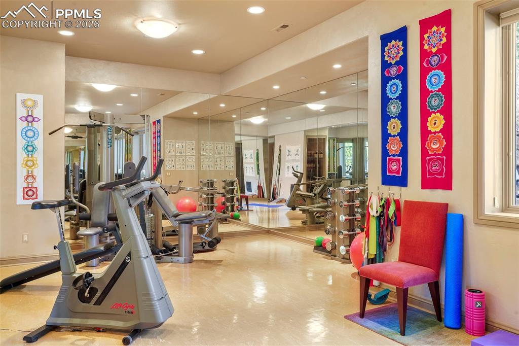 Image 38 of 50: 3rd Suite on lower level repurposed into full gym