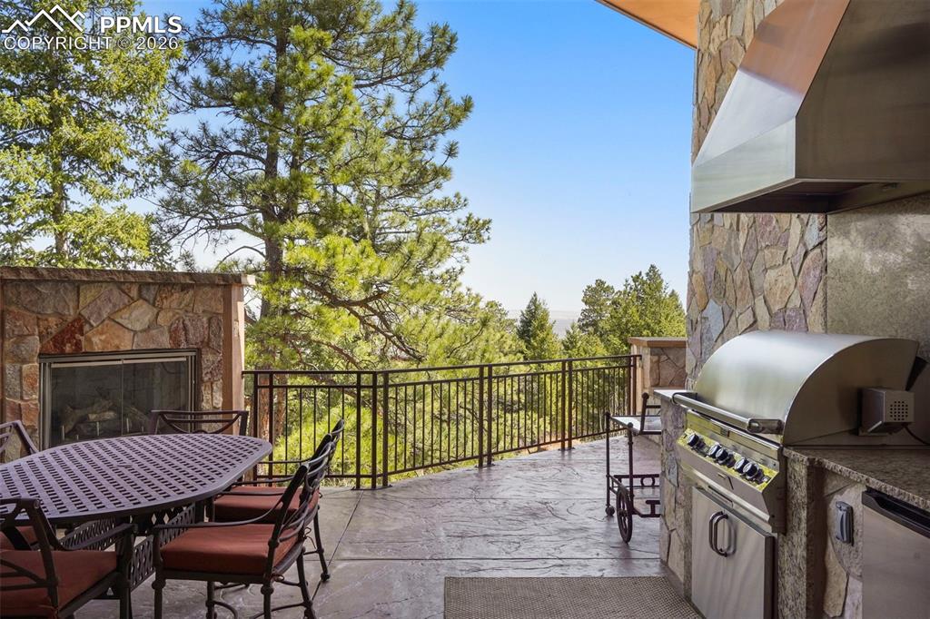 Image 46 of 50: Outdoor fireplace and full kitchen