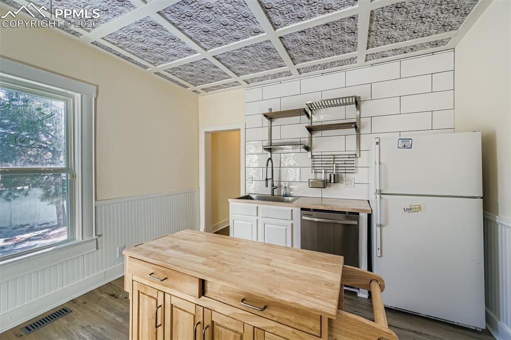 Image 15 of 38: Modern updates with mobile / removable island