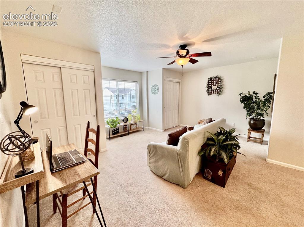 Image 16 of 36: Carpeted interior space featuring a ceiling fan with integrated lighting, a