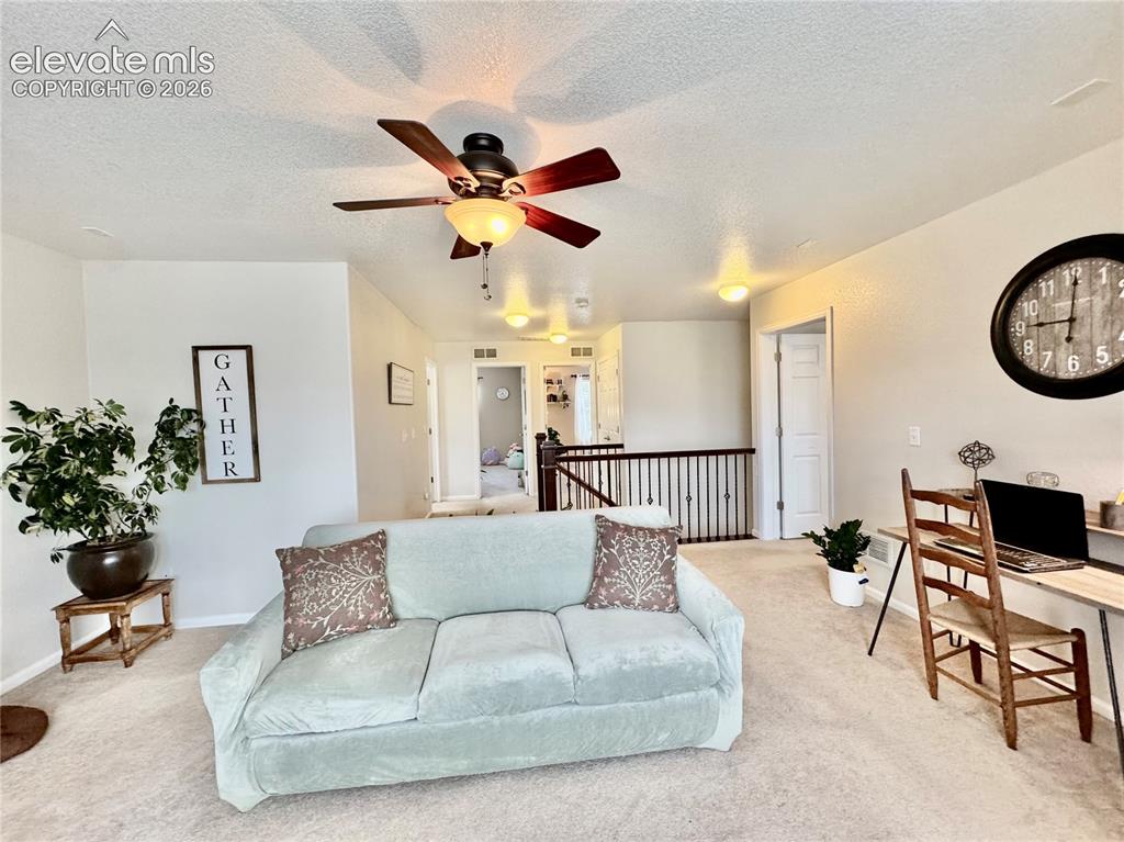 Image 17 of 36: Open loft space featuring carpet flooring and neutral wall tones