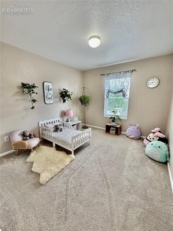 Image 29 of 36: Bright room featuring a window with blinds, a flush mount ceiling light, an