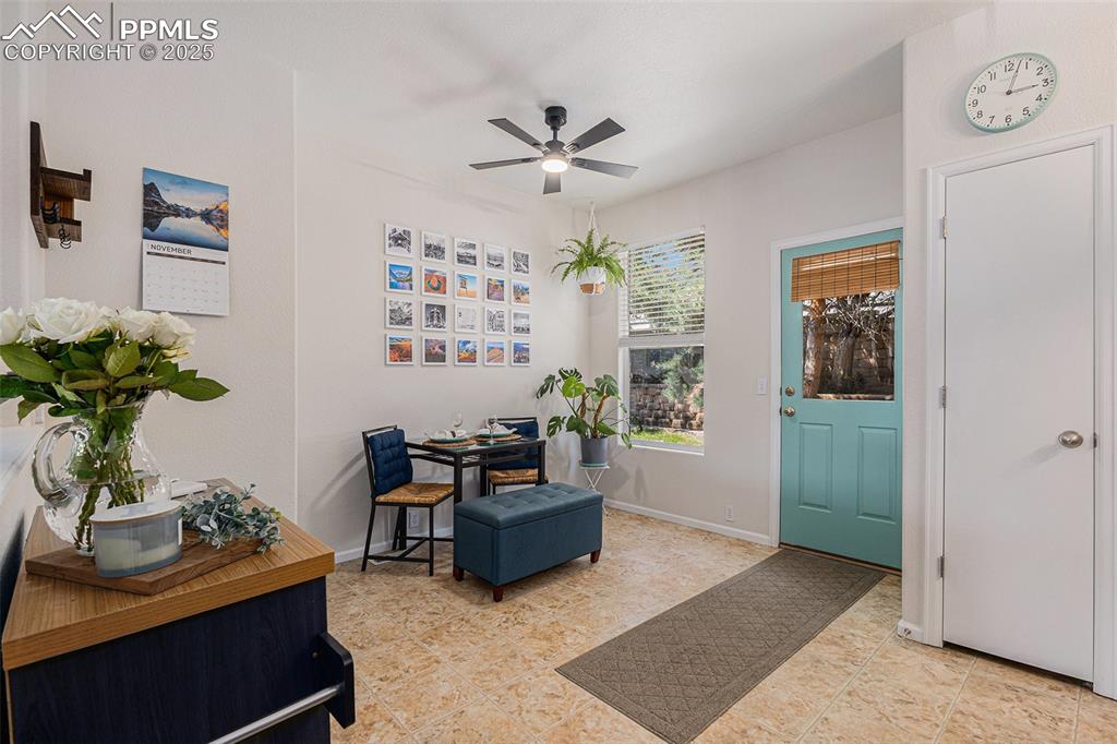 Image 11 of 24: Dining space with updated lighting and ceiling fan