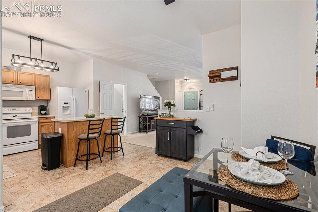 Image 12 of 24: Dining space with updated lighting and ceiling fan