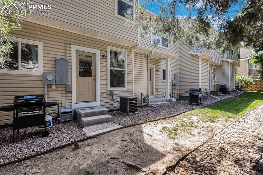 Image 20 of 24: Rear view of house with entry steps