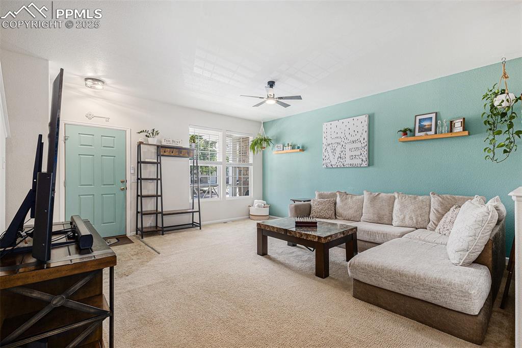 Image 5 of 24: Spacious carpeted Living room with updated ceiling fan