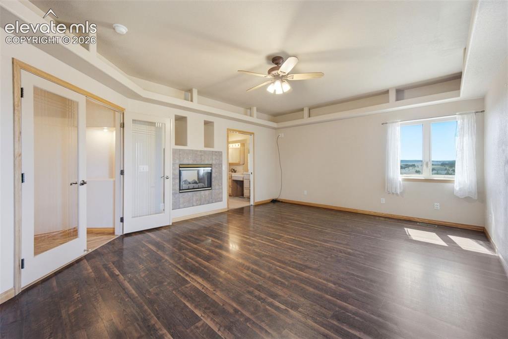 Image 18 of 39: Primary Bedroom with walkout to deck