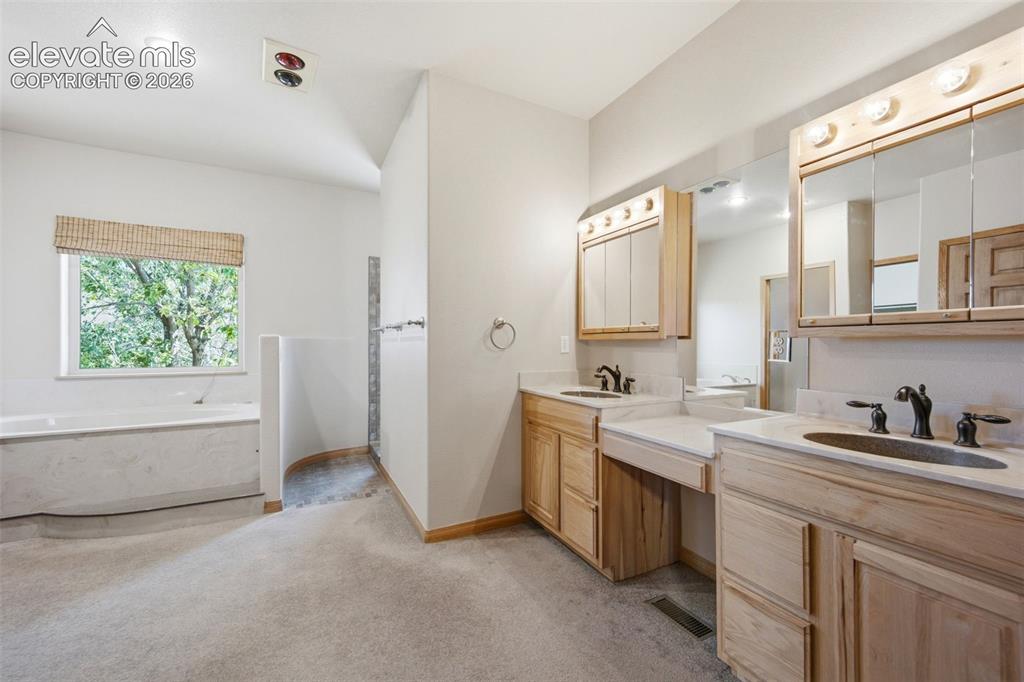 Image 19 of 39: Dual Vanity, walk-in Primary Bath features walk-in shower and stand alone t
