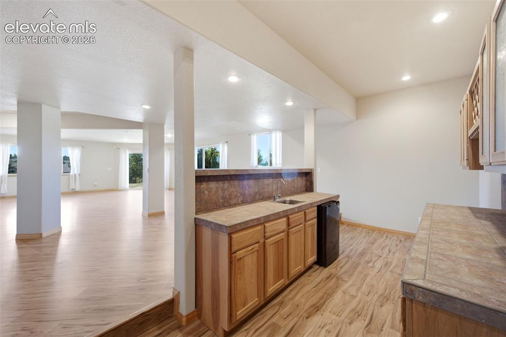 Image 26 of 39: Wet Bar with bar fridge and sink
