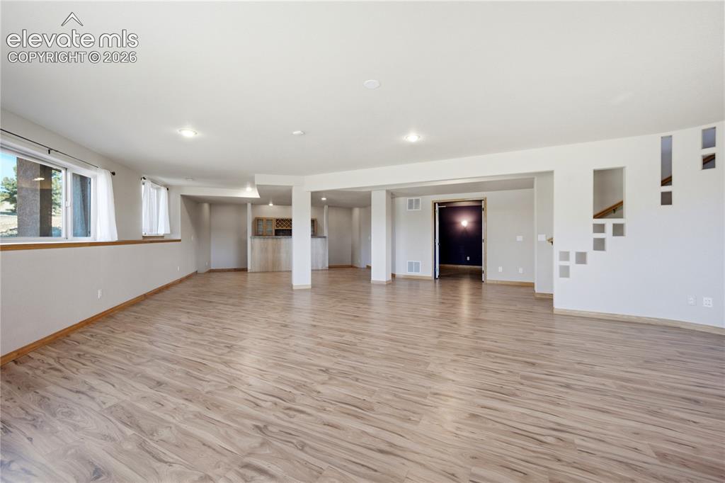 Image 27 of 48: Game Room with wet bar and adjacent theater room