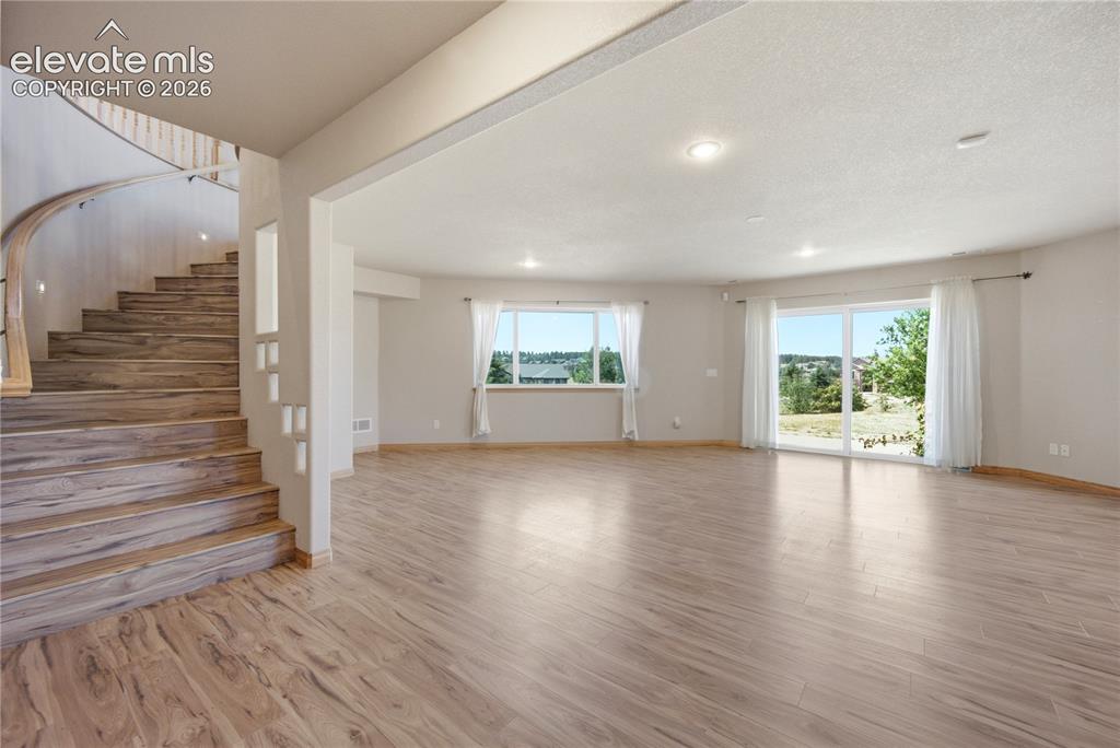 Image 28 of 48: Game Room with walkout to patio. wet bar and adjacent theater room