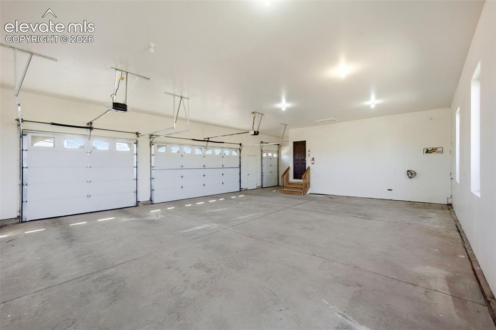 Image 30 of 39: Attached 3 car garage PLUS golf cart parking