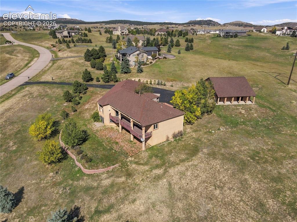 Image 45 of 48: Expansive property with easy-care stucco exterior, generous covered deck, a